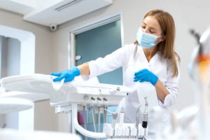 Our dentist sanitizing our dental clinic's equipment